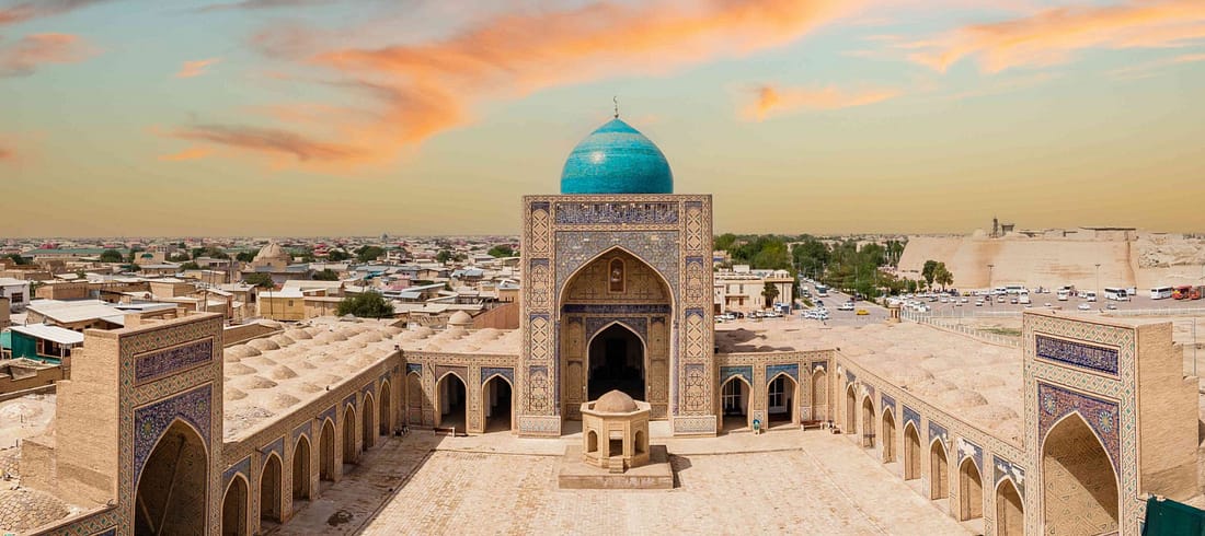 Historic madrasa with turquoise dome in Bukhara showcasing Uzbekistan Islamic architecture and cultural heritage